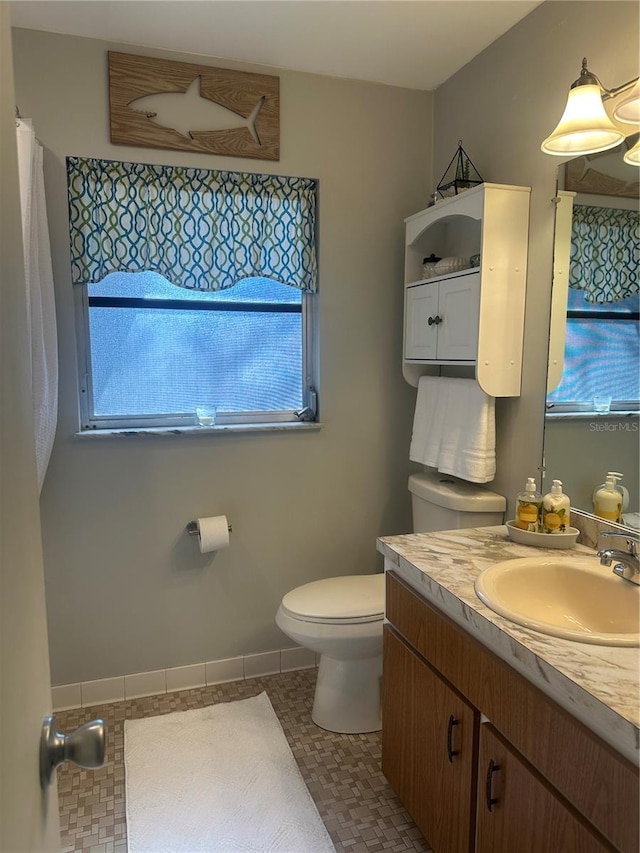 787 Alhambra Ave, Saint Augustine, FL 32086 - bathroom featuring baseboards, toilet, tile patterned floors, and vanity