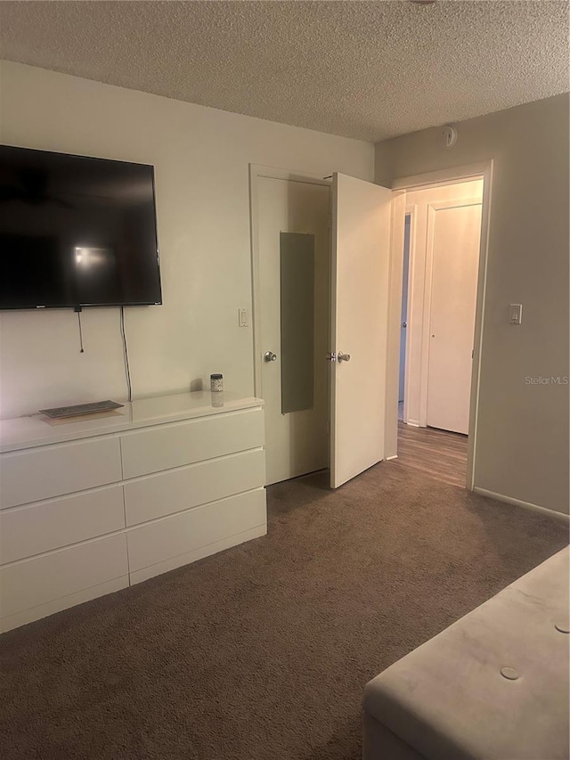 787 Alhambra Ave, Saint Augustine, FL 32086 - unfurnished bedroom with a textured ceiling and dark carpet