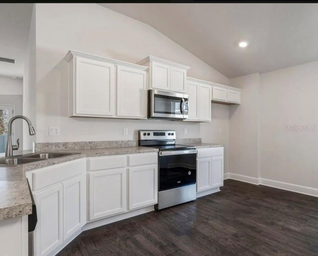 37 Rose Dr, Palm Coast, FL 32164 - kitchen with a sink, appliances with stainless steel finishes, white cabinets, light countertops, and dark wood-style flooring