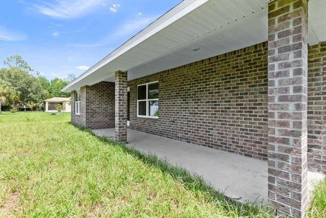 37 Rose Dr, Palm Coast, FL 32164 - view of home's exterior featuring a lawn and brick siding