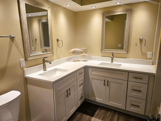 11 Cheyenne Ct, Palm Coast, FL 32137 - full bathroom with double vanity, toilet, wood finished floors, and recessed lighting