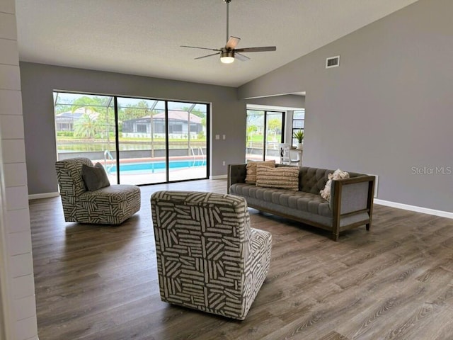 11 Cheyenne Ct, Palm Coast, FL 32137 - living area featuring a ceiling fan, dark wood-style flooring, vaulted ceiling, and baseboards