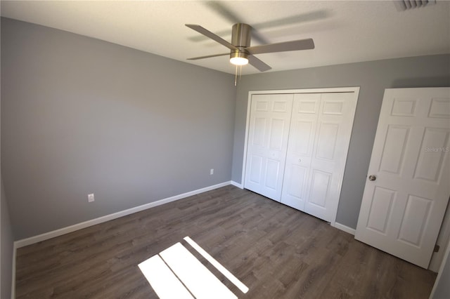 11 Cheyenne Ct, Palm Coast, FL 32137 - unfurnished bedroom featuring dark wood finished floors, baseboards, a closet, and ceiling fan