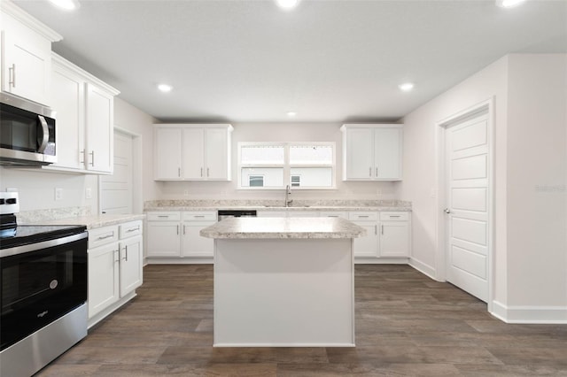 48 Sedgwick Trl, Palm Coast, FL 32164 - kitchen with white cabinetry, dark wood-style flooring, a sink, and stainless steel appliances