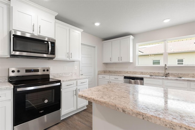 48 Sedgwick Trl, Palm Coast, FL 32164 - kitchen with white cabinetry, a sink, stainless steel appliances, and dark wood finished floors