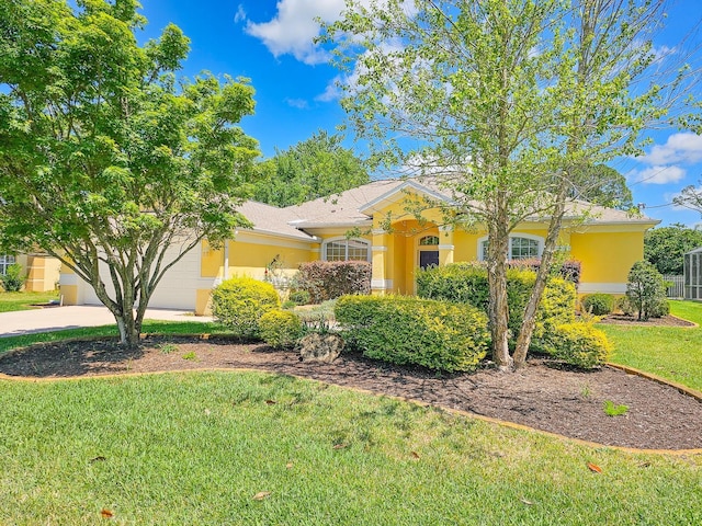 view of front of property featuring a front yard, driveway, a garage, and stucco siding