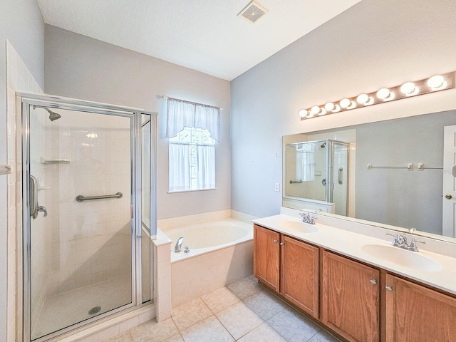 bathroom featuring a sink, a bath, a stall shower, double vanity, and visible vents