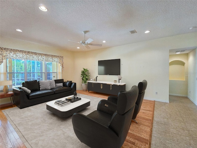 living area with recessed lighting, a textured ceiling, visible vents, and ceiling fan