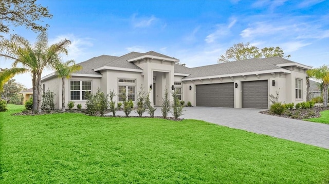 29 Old Oak Dr S, Palm Coast, FL 32137 - view of front of property featuring a front lawn, decorative driveway, stucco siding, and a garage