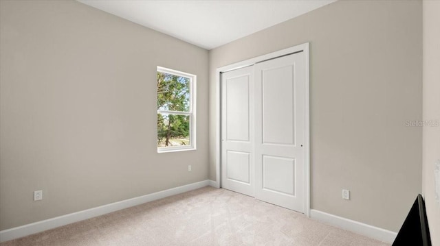 29 Old Oak Dr S, Palm Coast, FL 32137 - unfurnished bedroom featuring light colored carpet, a closet, and baseboards