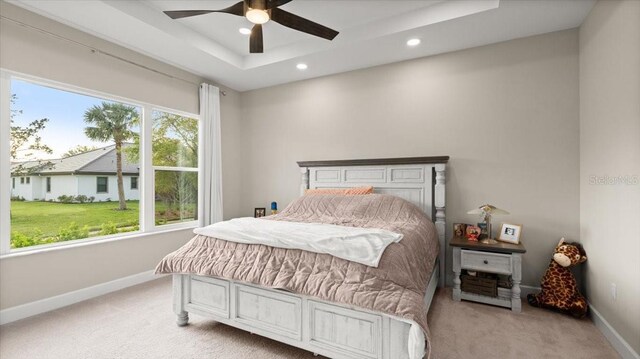 29 Old Oak Dr S, Palm Coast, FL 32137 - bedroom featuring light carpet, baseboards, multiple windows, and a tray ceiling