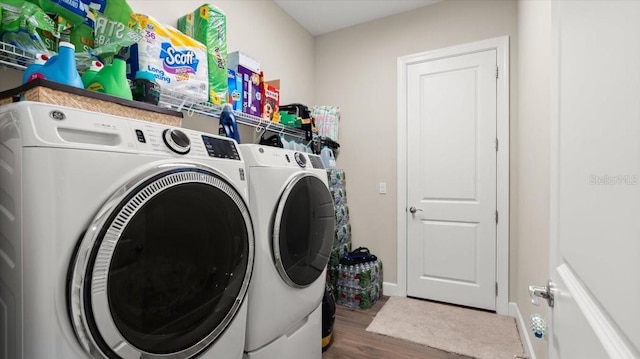 29 Old Oak Dr S, Palm Coast, FL 32137 - laundry area with baseboards, wood finished floors, washing machine and clothes dryer, and laundry area