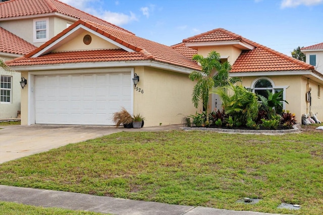 mediterranean / spanish house featuring a front yard, stucco siding, a tiled roof, and a garage