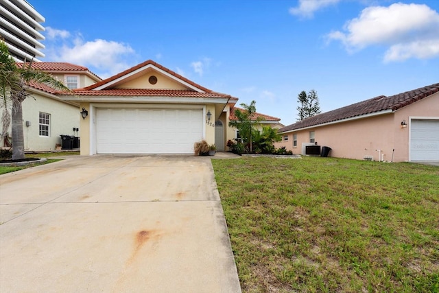 view of front of home with a tile roof, stucco siding, an attached garage, driveway, and a front yard