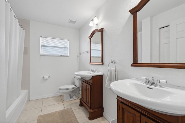 bathroom with visible vents, baseboards, toilet, vanity, and tile patterned flooring