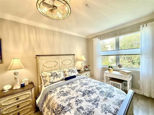 45 Riverview Bnd S Unit 1937, Palm Coast, FL 32137 - bedroom with wood finished floors, ornamental molding, a chandelier, a textured ceiling, and baseboards