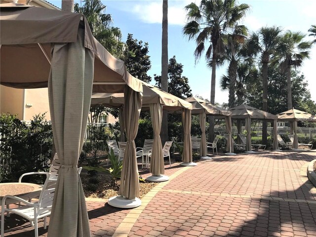 45 Riverview Bnd S Unit 1937, Palm Coast, FL 32137 - view of patio / terrace with a gazebo, fence, and outdoor dining space