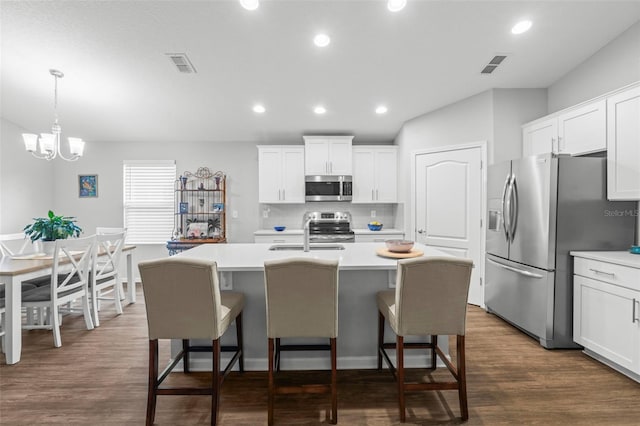 324 Palace Dr, Saint Augustine, FL 32084 - kitchen featuring appliances with stainless steel finishes, light countertops, an island with sink, a breakfast bar area, and recessed lighting