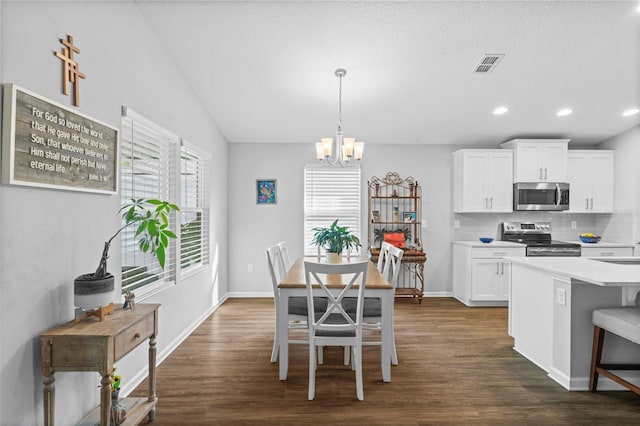 324 Palace Dr, Saint Augustine, FL 32084 - dining space featuring a chandelier, dark wood-type flooring, recessed lighting, and vaulted ceiling