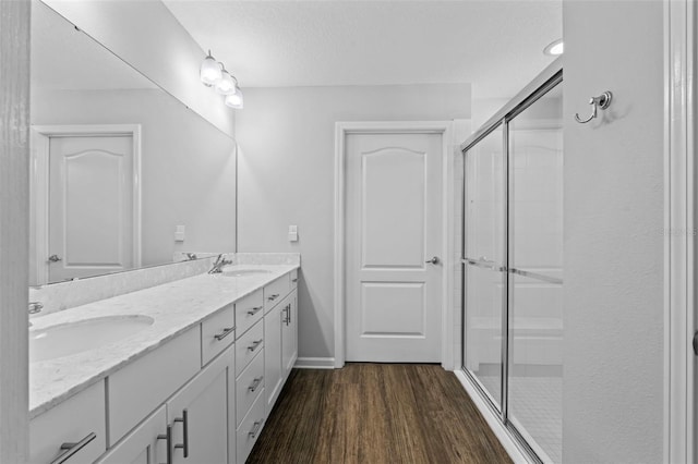 324 Palace Dr, Saint Augustine, FL 32084 - full bathroom featuring double vanity, a shower stall, and wood finished floors