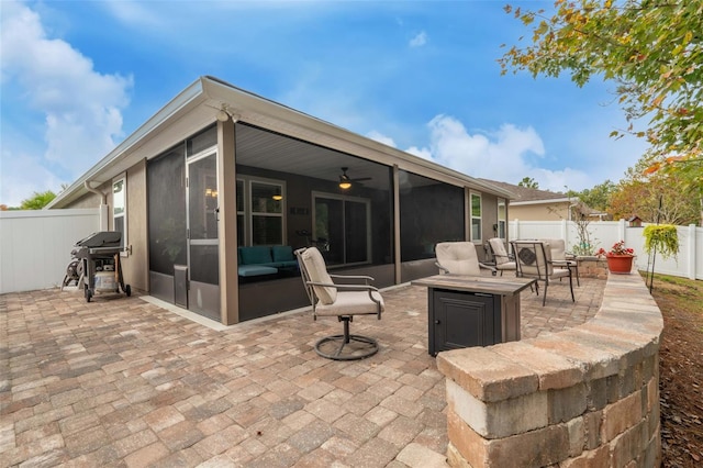 324 Palace Dr, Saint Augustine, FL 32084 - fenced backyard with grilling area, a patio area, a sunroom, ceiling fan, and an outdoor living space with a fire pit