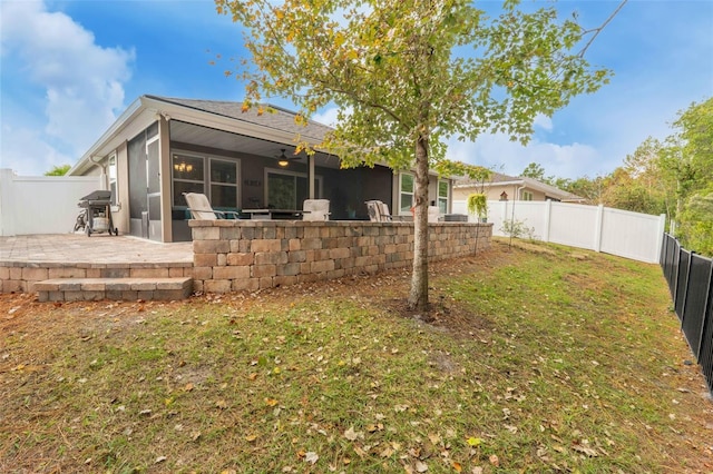 324 Palace Dr, Saint Augustine, FL 32084 - rear view of house featuring a fenced backyard, a patio, and a sunroom