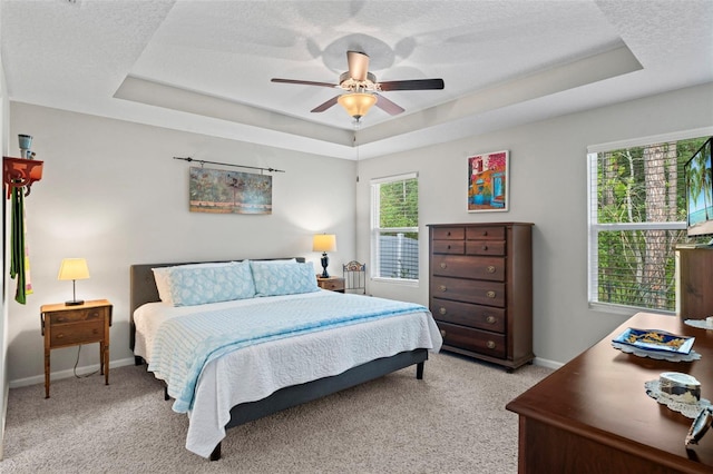 324 Palace Dr, Saint Augustine, FL 32084 - bedroom with a raised ceiling, light colored carpet, a ceiling fan, and a textured ceiling