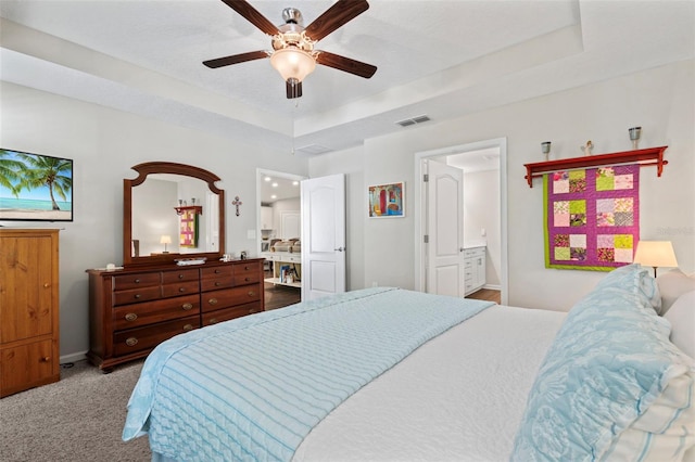 324 Palace Dr, Saint Augustine, FL 32084 - bedroom featuring carpet flooring, a raised ceiling, ensuite bath, and a ceiling fan