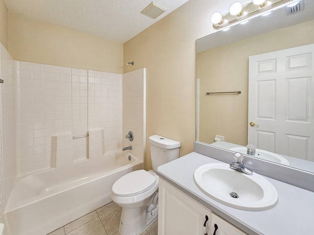 18 Wheatfield Dr, Palm Coast, FL 32164 - bathroom with tile patterned flooring, toilet, washtub / shower combination, a textured ceiling, and vanity