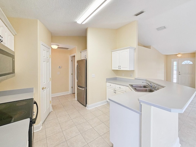 18 Wheatfield Dr, Palm Coast, FL 32164 - kitchen with appliances with stainless steel finishes, a peninsula, light tile patterned floors, a sink, and white cabinets