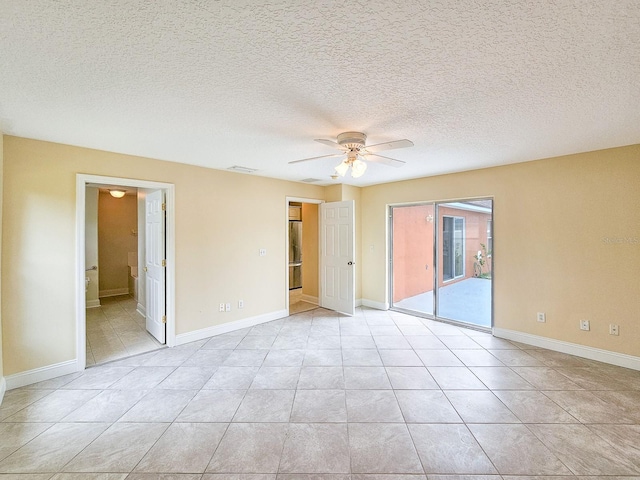 18 Wheatfield Dr, Palm Coast, FL 32164 - unfurnished bedroom featuring access to outside, light tile patterned flooring, baseboards, ceiling fan, and freestanding refrigerator