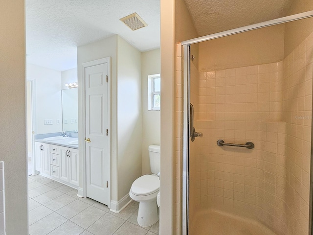 18 Wheatfield Dr, Palm Coast, FL 32164 - full bath featuring tile patterned floors, a shower stall, toilet, a textured ceiling, and vanity