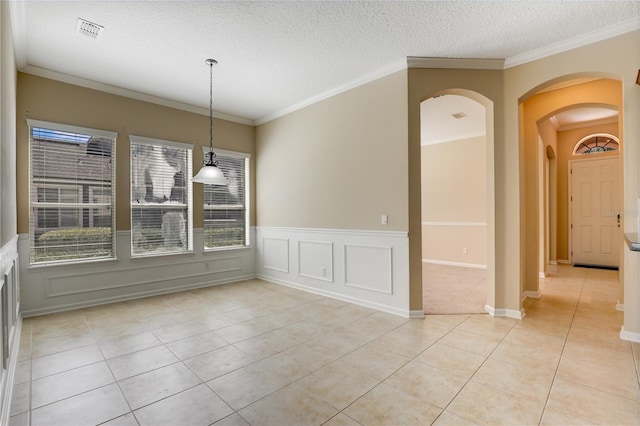 4484 Gray Hawk St, Orange Park, FL 32065 - unfurnished dining area featuring crown molding, a textured ceiling, light tile patterned floors, visible vents, and arched walkways