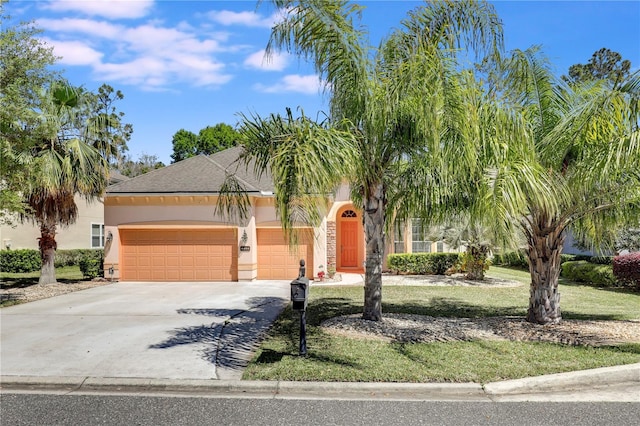 4484 Gray Hawk St, Orange Park, FL 32065 - view of property hidden behind natural elements with driveway, stucco siding, a front yard, and a garage