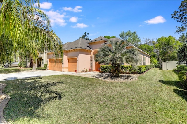 4484 Gray Hawk St, Orange Park, FL 32065 - view of front of home with stucco siding, fence, driveway, a front lawn, and a garage