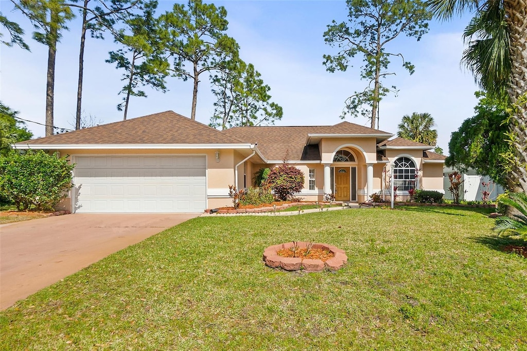 28 Woodlyn Ln, Palm Coast, FL 32164 - view of front of property with a front yard, stucco siding, a garage, and concrete driveway