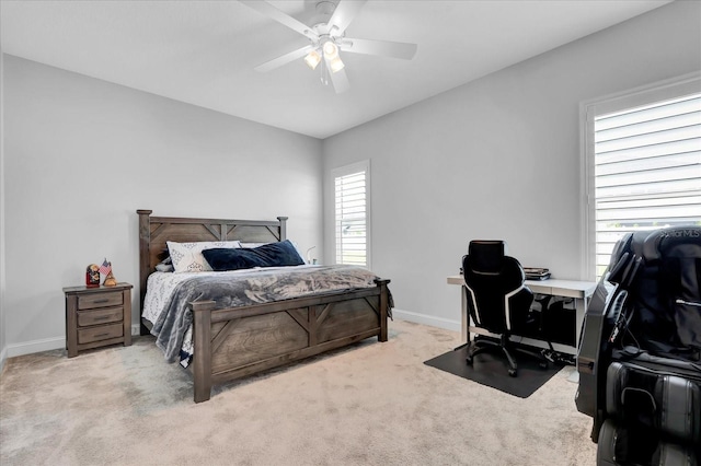 bedroom with ceiling fan, carpet flooring, and baseboards