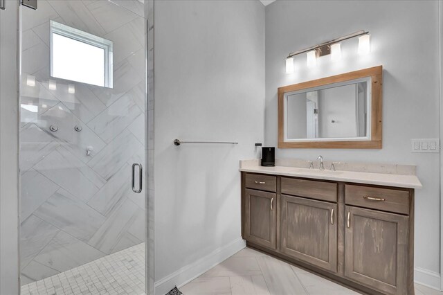full bathroom featuring a shower stall, vanity, and baseboards