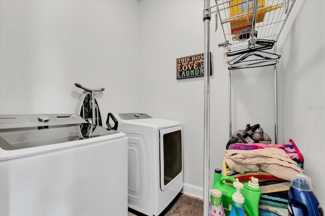 laundry room with separate washer and dryer, laundry area, and wood finished floors