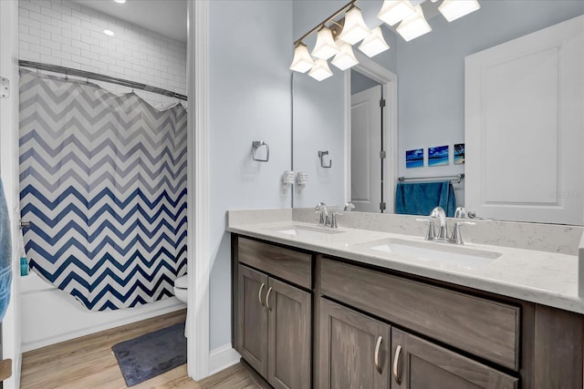 bathroom with a sink, double vanity, and a shower with curtain