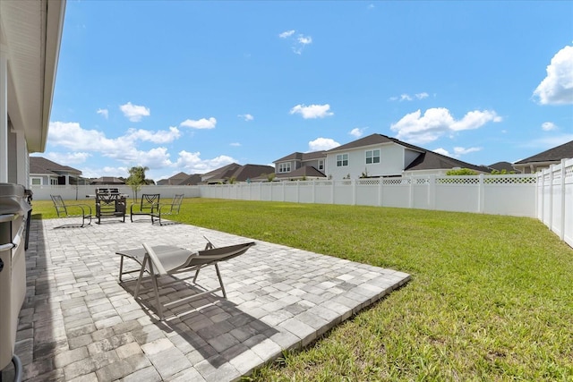 view of yard with a patio area, a residential view, and a fenced backyard