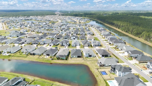 aerial view featuring a water view, a residential view, and a view of trees