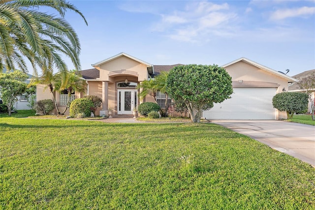 16 London Dr, Palm Coast, FL 32137 - view of front of property with an attached garage, a front lawn, driveway, and stucco siding