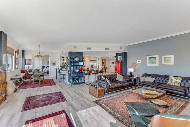 925 N Halifax Ave Unit 1105, Daytona Beach, FL 32118 - living room featuring visible vents, wood finished floors, a notable chandelier, and ornamental molding