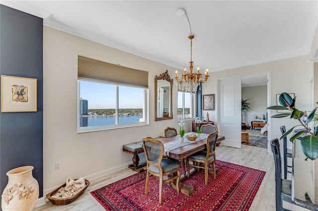 925 N Halifax Ave Unit 1105, Daytona Beach, FL 32118 - dining room with an inviting chandelier, ornamental molding, and light wood-style floors
