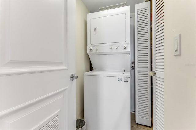 925 N Halifax Ave Unit 1105, Daytona Beach, FL 32118 - laundry area with tile patterned floors, stacked washer and clothes dryer, and laundry area