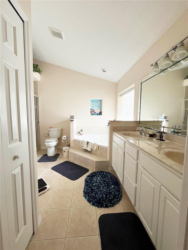 161 Frontier Dr, Palm Coast, FL 32137 - full bath with a garden tub, a sink, toilet, and tile patterned flooring