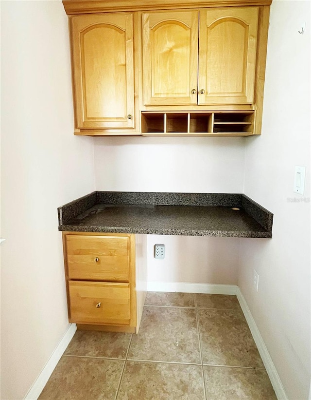 161 Frontier Dr, Palm Coast, FL 32137 - kitchen with dark countertops, baseboards, and light tile patterned floors