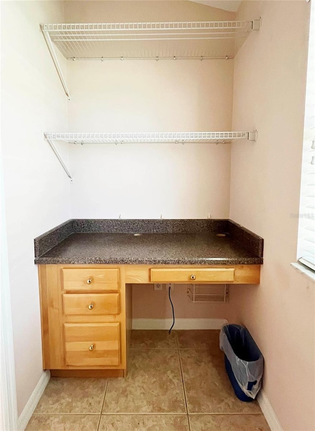 161 Frontier Dr, Palm Coast, FL 32137 - unfurnished office with built in study area, baseboards, and light tile patterned floors