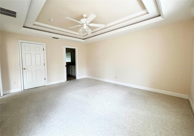 161 Frontier Dr, Palm Coast, FL 32137 - unfurnished bedroom with a tray ceiling, carpet flooring, baseboards, and ceiling fan